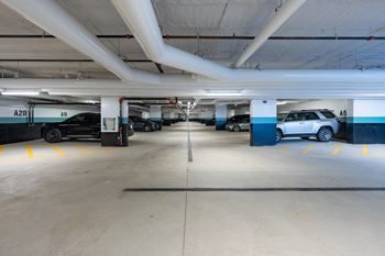 A parking garage with cars parked in it